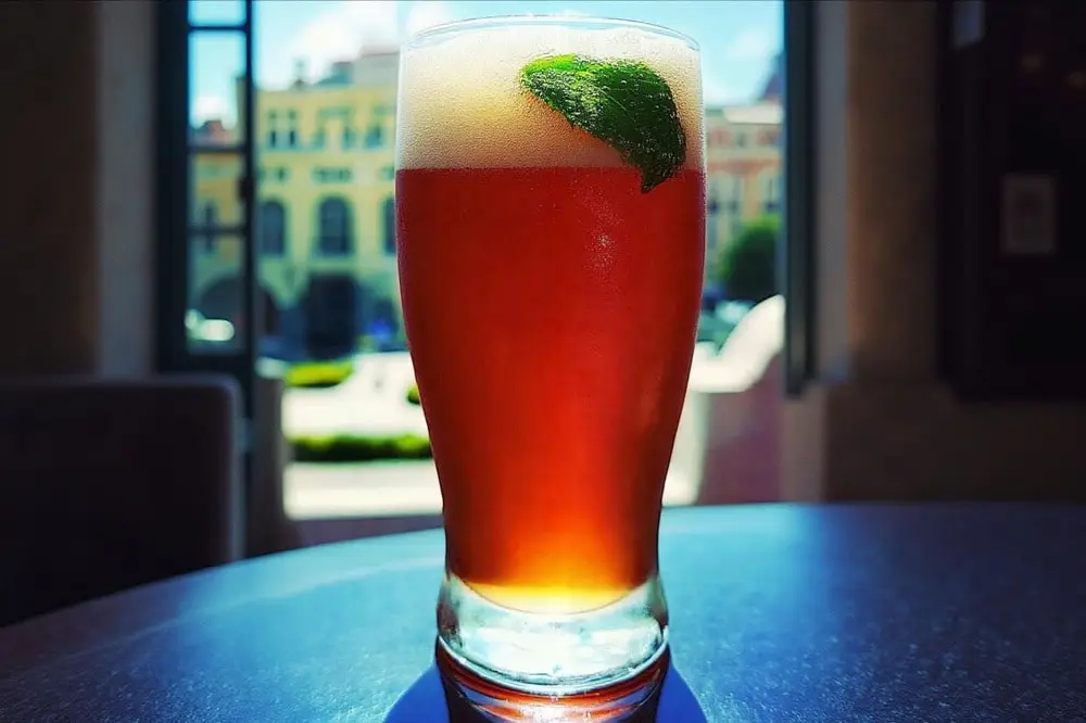 Monaco drink recipe: refreshing Monaco cocktail in a highball glass garnished with lime and mint