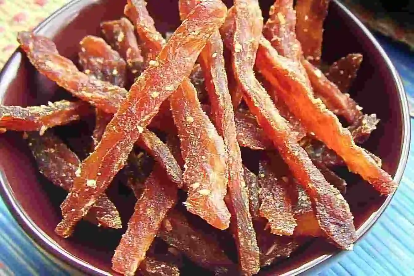 Close-up of crispy salmon jerky strips, a healthy protein-packed snack.