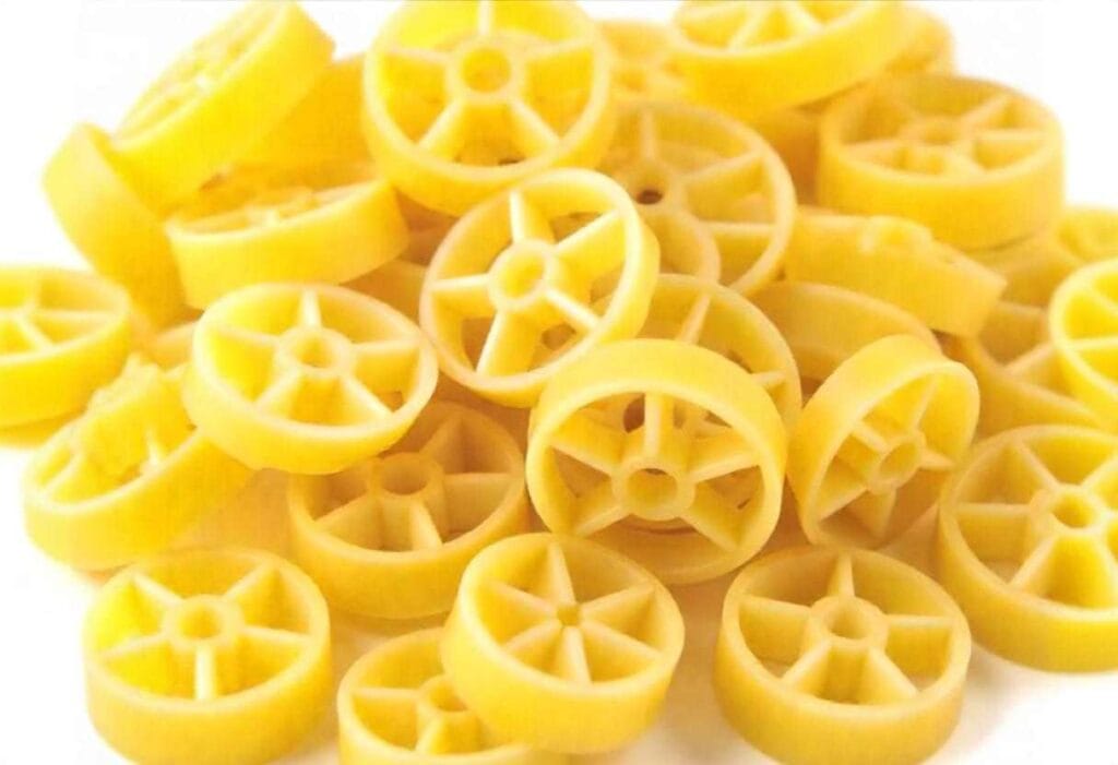 Close-up of a plate of pasta wheels, perfectly cooked and served with a rich tomato sauce.